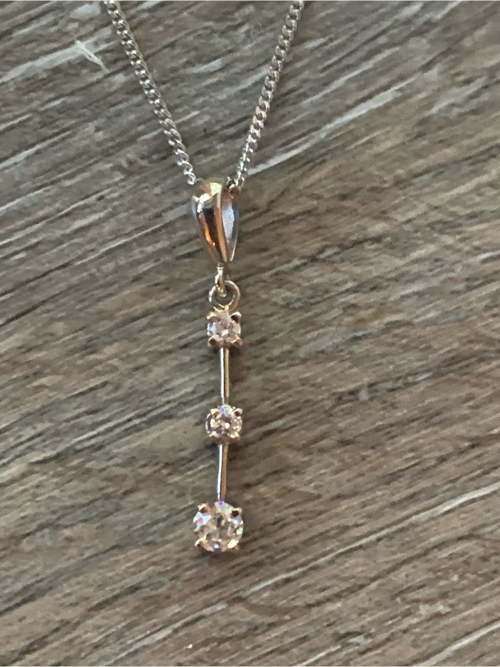 14k White gold chain with three diamond pendant.